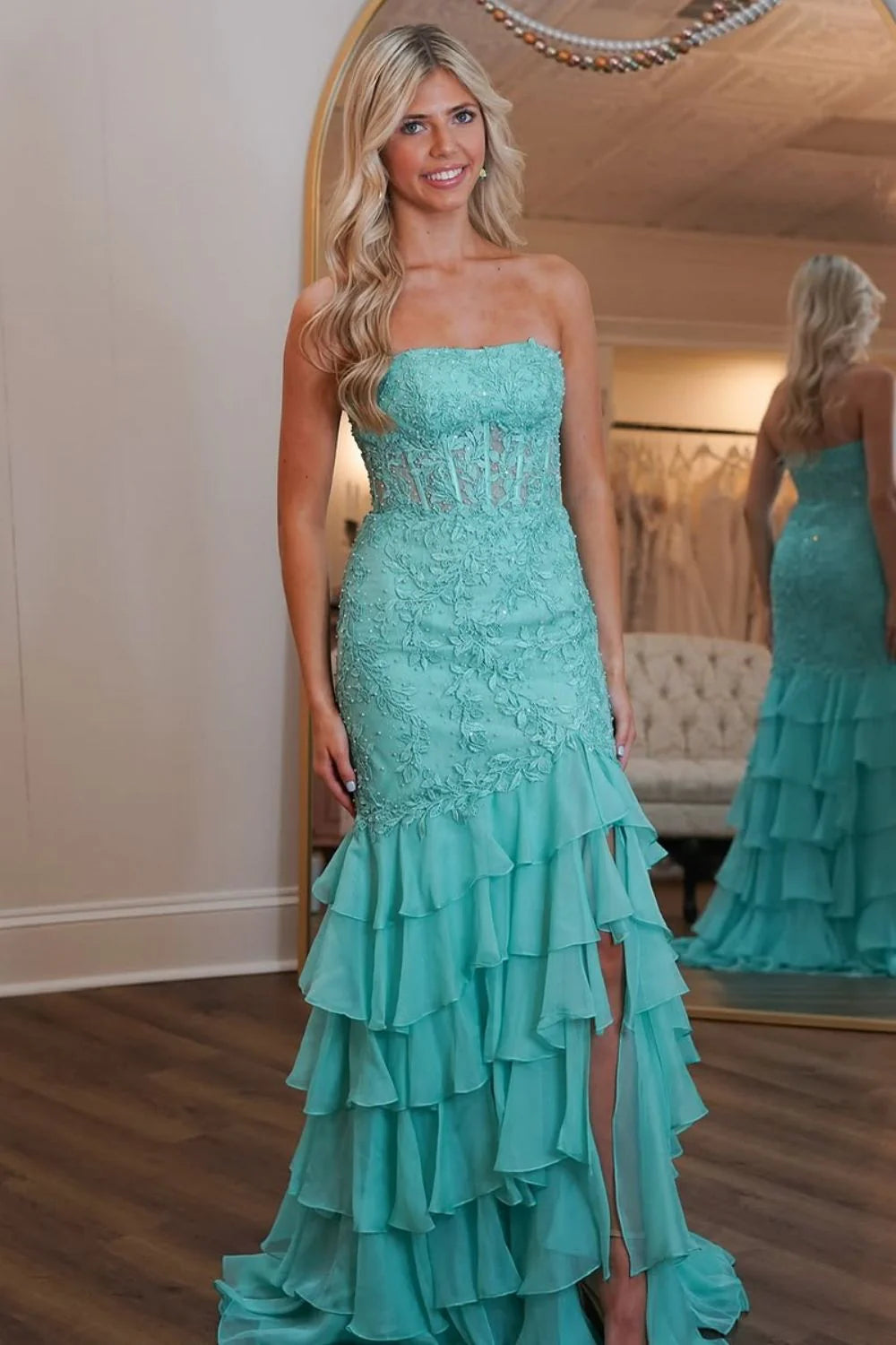 Mint green mermaid prom dress with strapless lace top and tiered skirt.