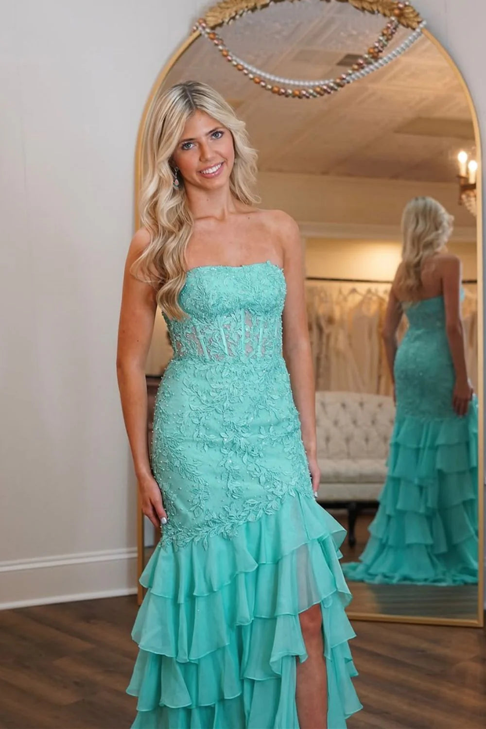 Side view of mint green prom dress highlighting beaded lace top and slit.
