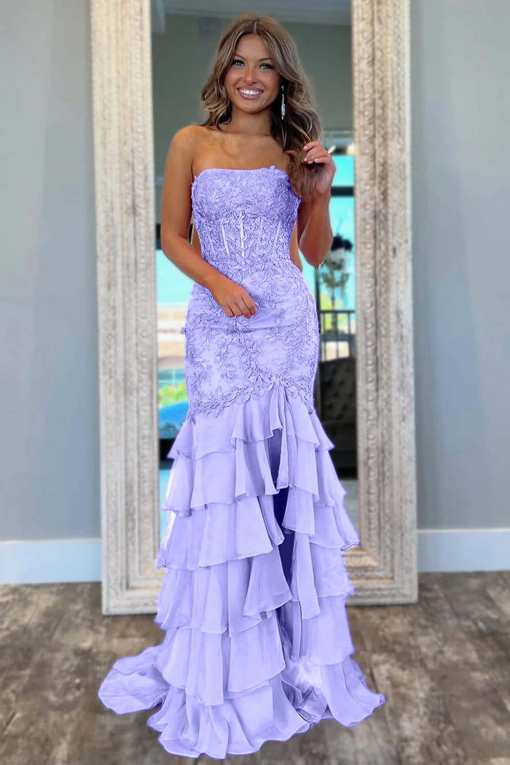 Elegant mint green mermaid gown with tiered skirt and strapless design.