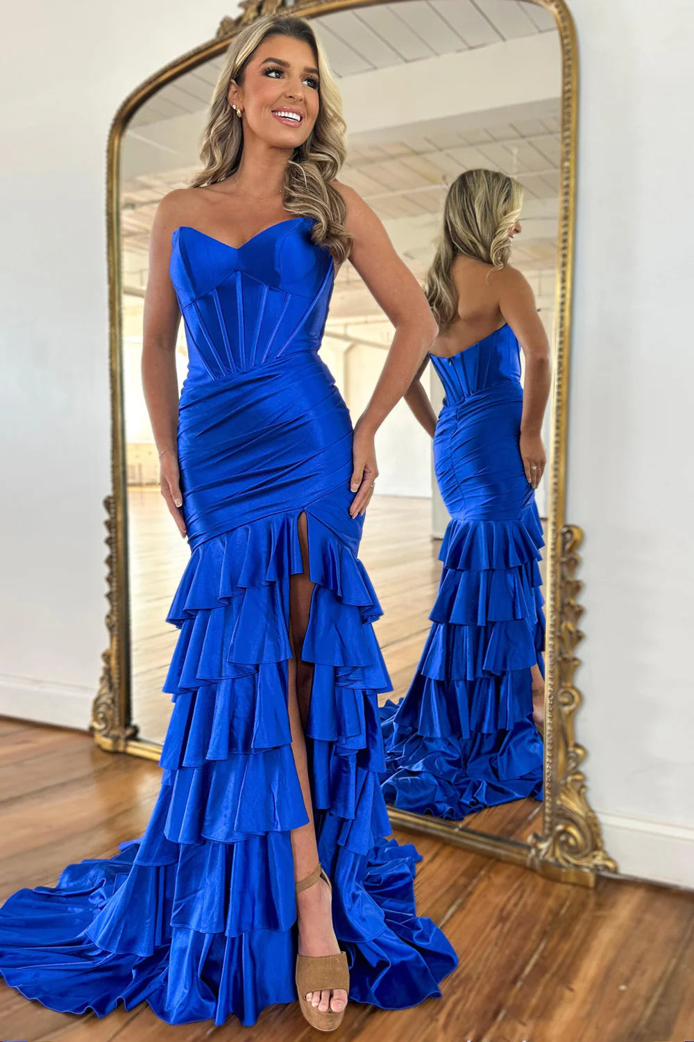 Royal blue mermaid prom dress with strapless neckline and ruffle tiered skirt.