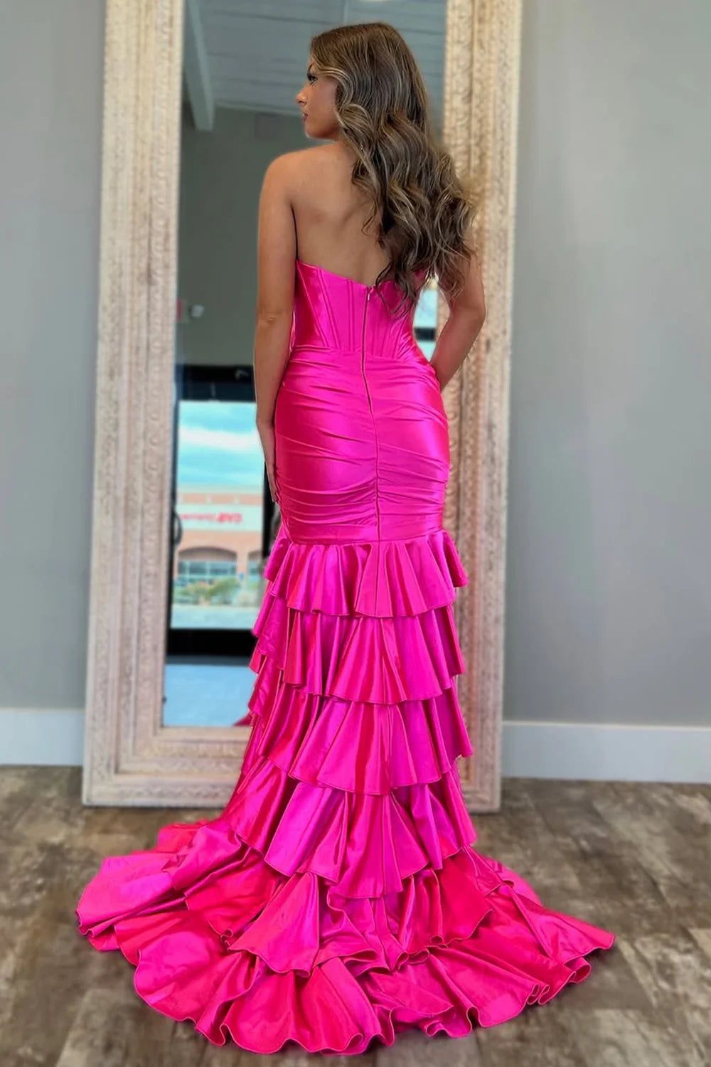 Side profile of a royal blue mermaid prom dress showcasing the high slit and train.