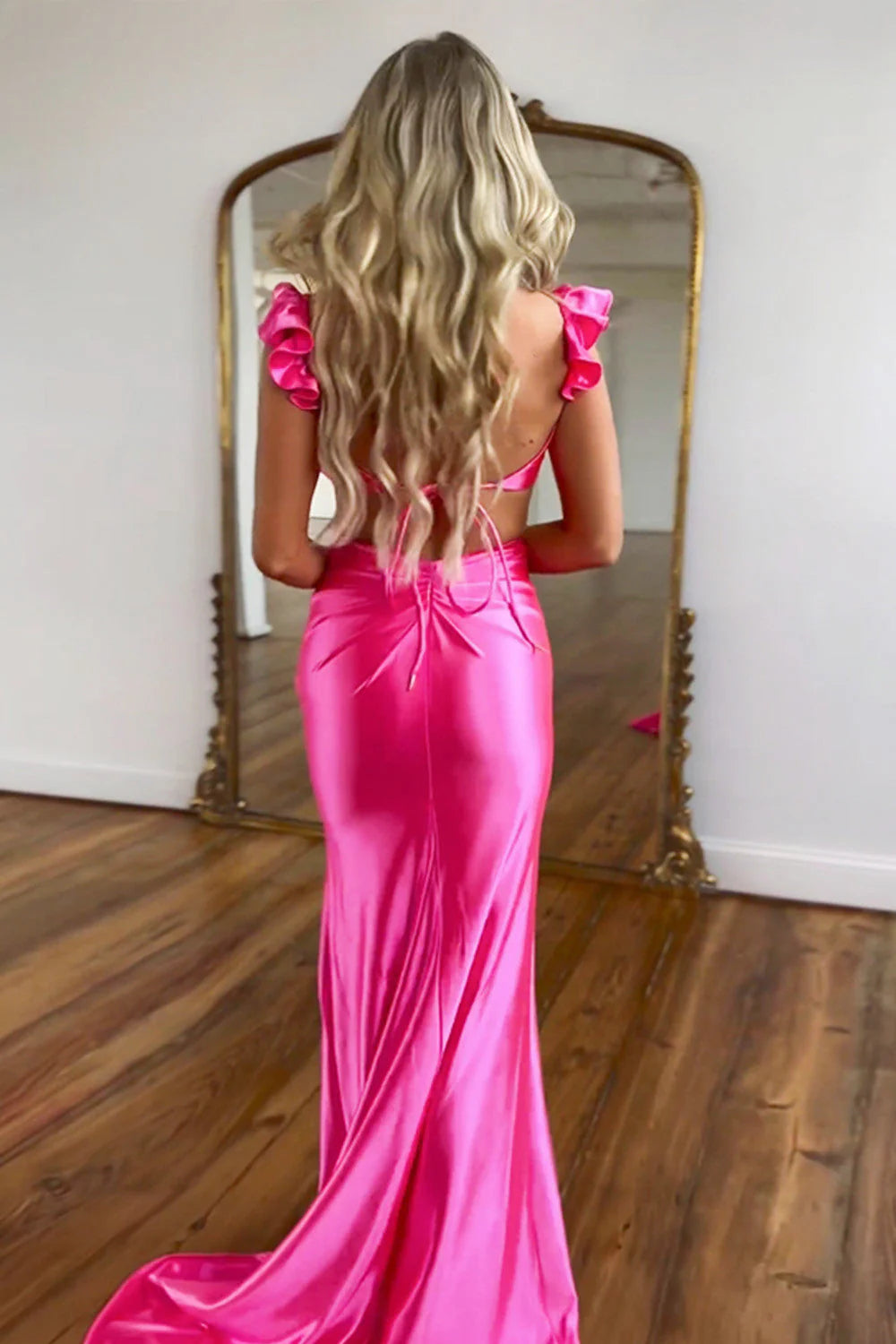 Back view of the hot pink mermaid prom dress, showing the tie-back detail.