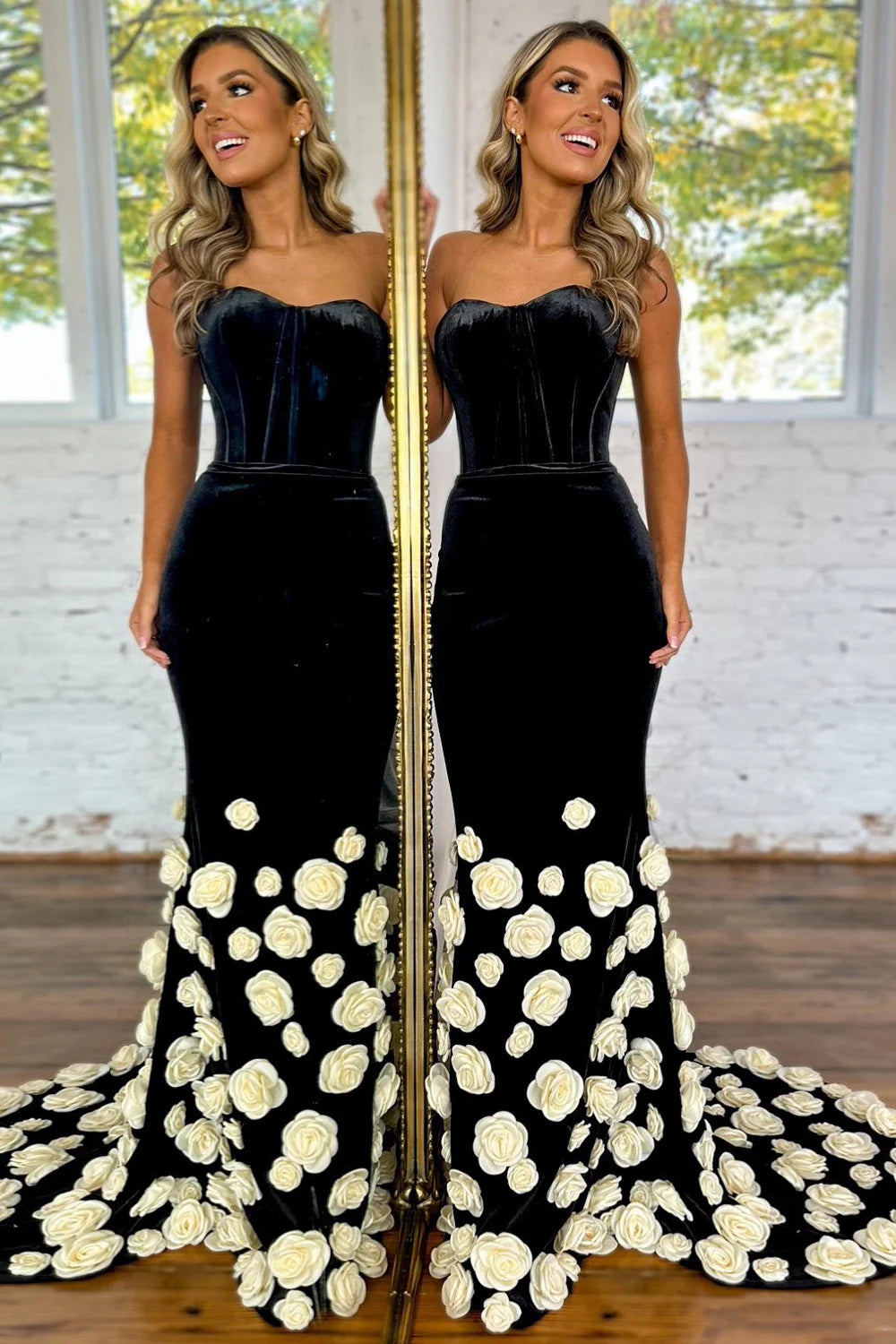 Elegant black velvet mermaid prom dress with sweetheart neckline and white 3D floral embellishments.