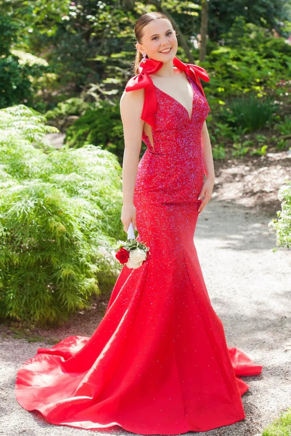 Model wearing a yellow mermaid prom dress with V-neck, intricate beading, and a charming bowknot.