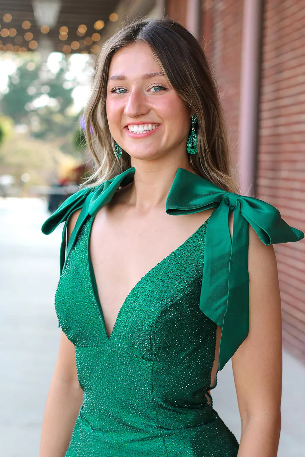 Front view of a model posing in the yellow V-neck beaded mermaid prom dress.