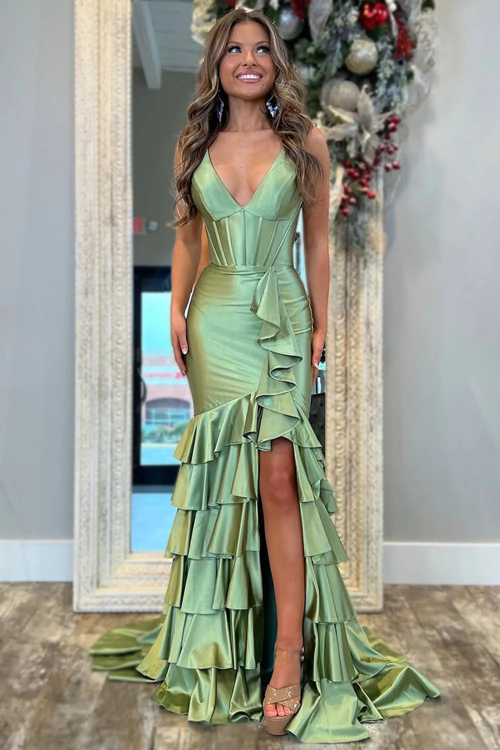 Elegant sage green mermaid prom dress with V-neck and ruffle tiers.