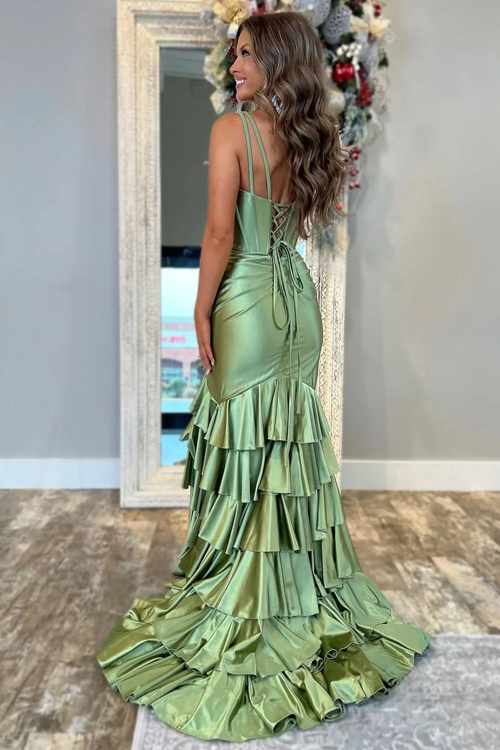Back view of sage green mermaid dress showing lace-up detail.