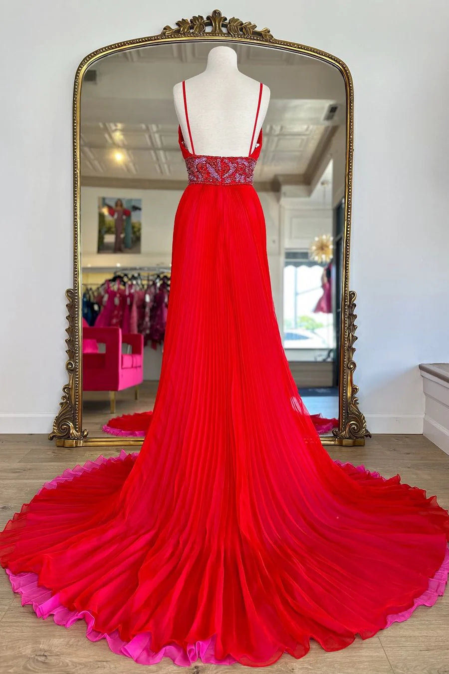 Red A-Line prom dress featuring an open back and flowing court train.