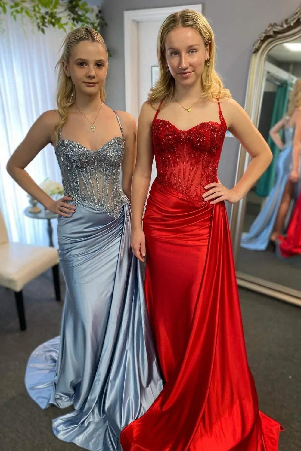 Side profile of a red mermaid evening gown, highlighting the flattering silhouette and thigh-high slit.