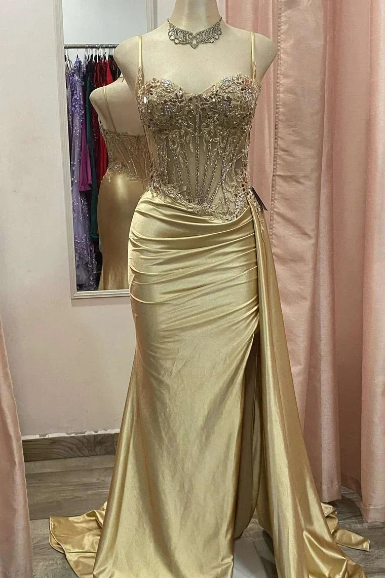Close-up of the intricately beaded bodice on a red spaghetti strap formal dress.