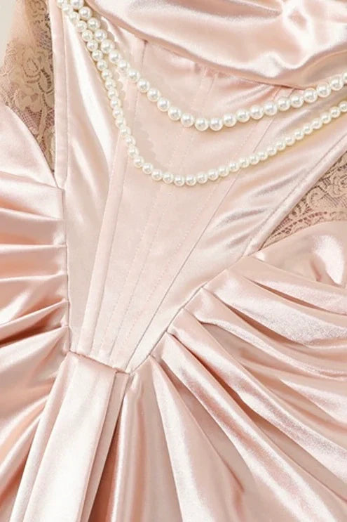 Front view of pink tea-length mermaid dress with off-shoulder neckline and pearl embellishments.