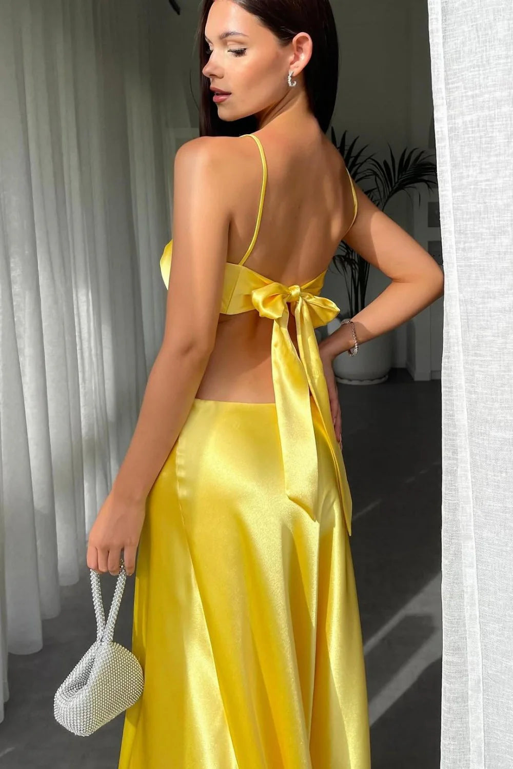 Full length front view of a woman in a mint green sheath prom dress.