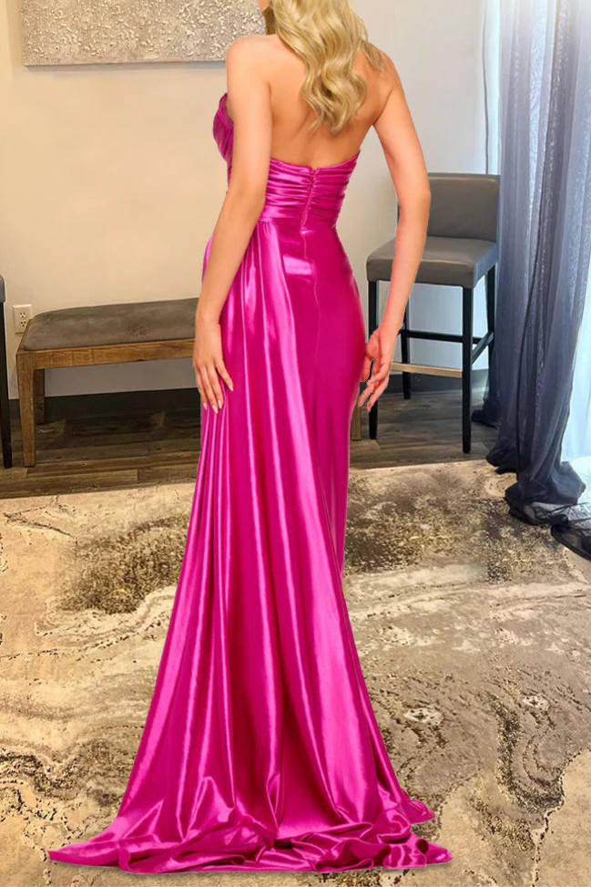 Back view of a model in a hot pink prom dress, showcasing the elegant streamer detail and zipper closure.