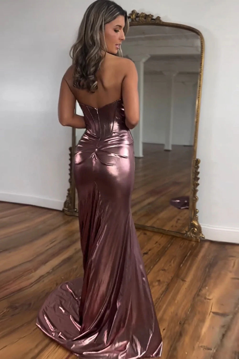 Back view of a metallic magenta mermaid prom dress, showcasing the zipper closure.