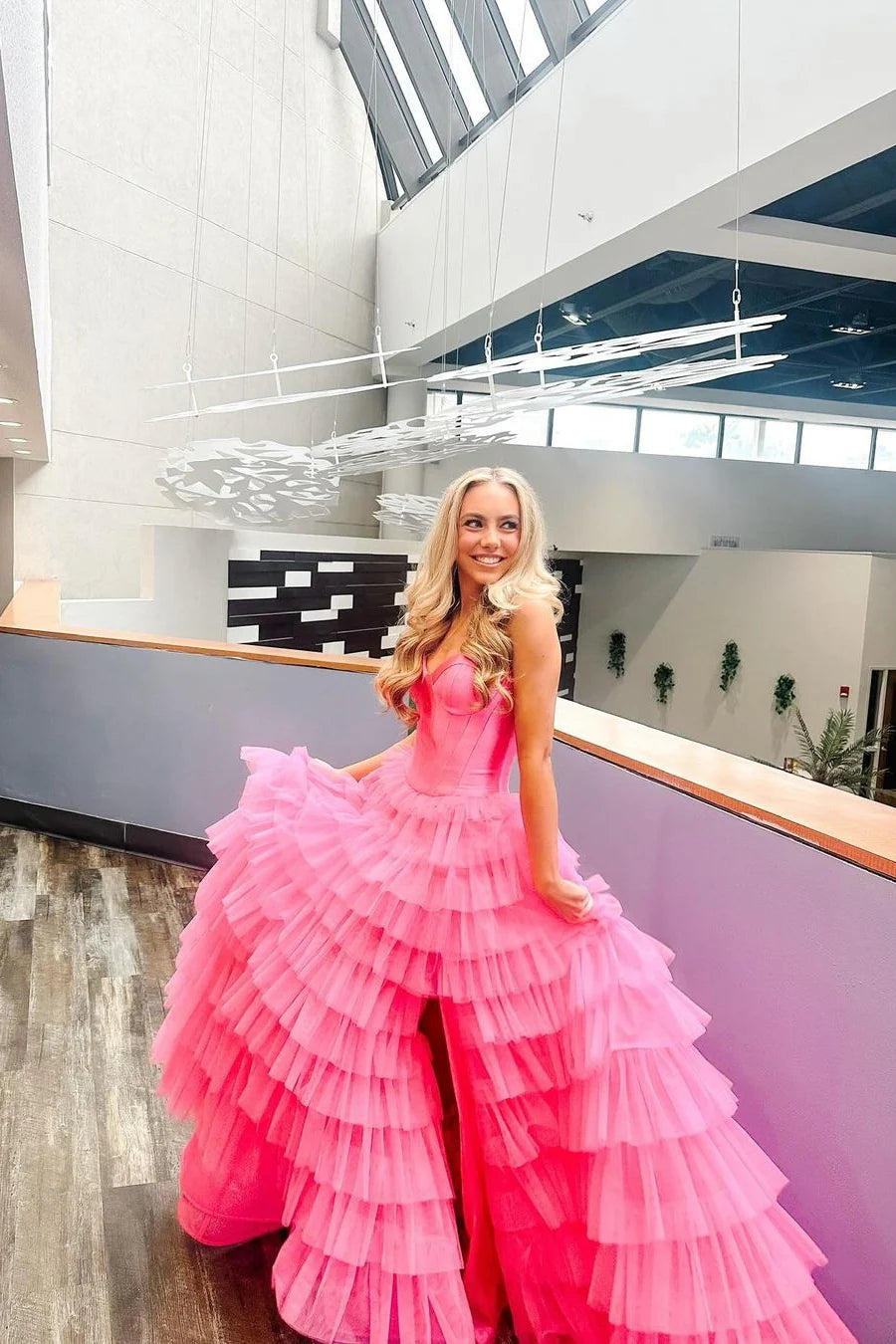 Front view of a green A-line sweetheart ruffled tiered prom dress with a graceful slit.