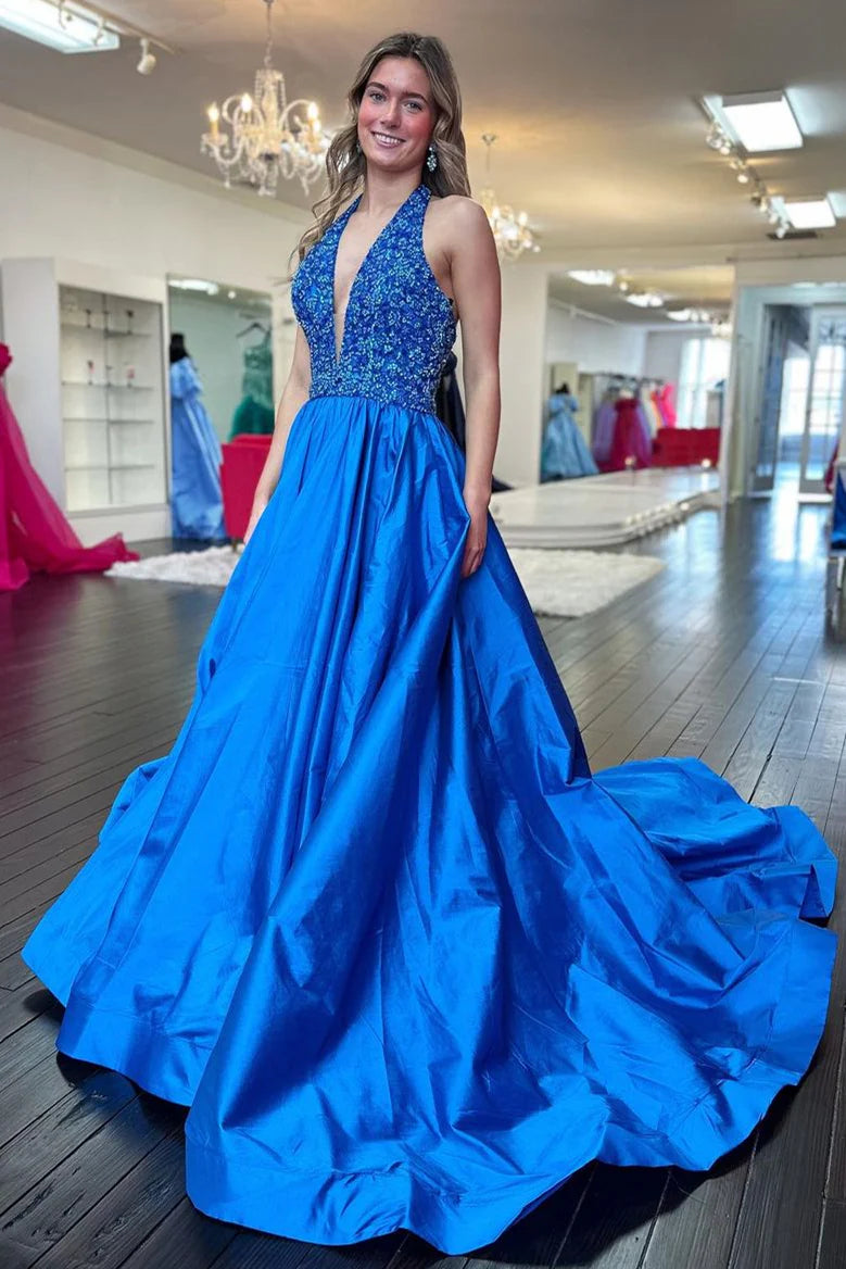 Model in blue A-line halter deep V-neck sequin satin prom dress with train, open back view.