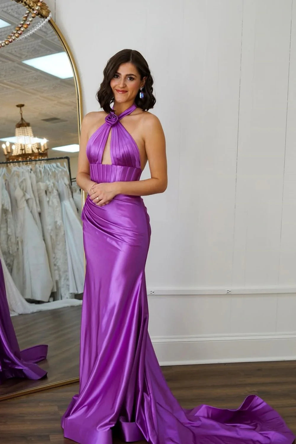 Close-up of the halter neck and backless detail of the satin prom dress.